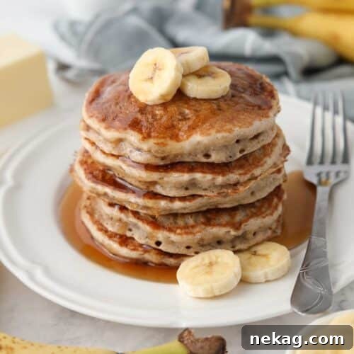 Fluffy 4-Ingredient Banana Pancakes Without Eggs 7 Stack of fluffy banana pancakes made with a pancake mix.