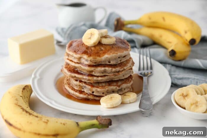 Fluffy 4-Ingredient Banana Pancakes Without Eggs 6 Stack of fluffy banana pancakes made with a pancake mix.