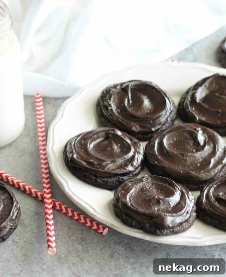 Fudgy dark chocolate sugar cookies are frosted with a creamy chocolate buttercream frosting.