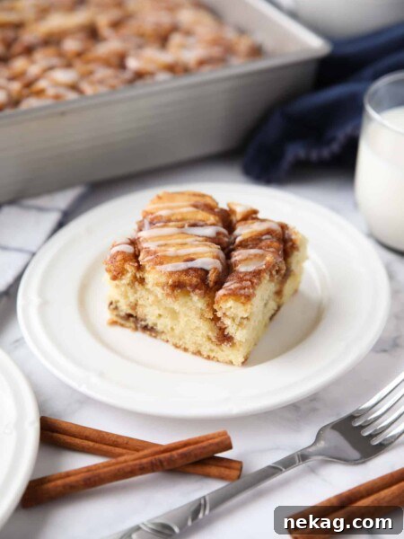 A fluffy vanilla cake filled with cinnamon swirls just like a cinnamon roll.