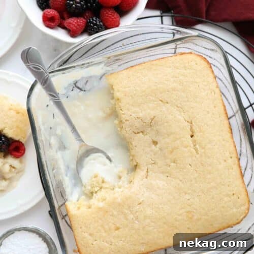Top view of vanilla pudding cake in a baking pan with vanilla cake on top and vanilla pudding on bottom.