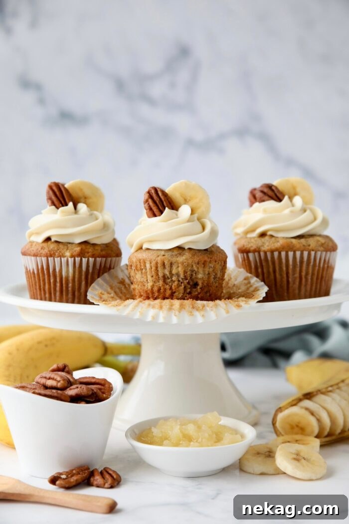 Southern-Style Hummingbird Cupcakes with Cream Cheese Frosting 11 Wrapper removed from a banana pineapple pecan cupcake to show texture.