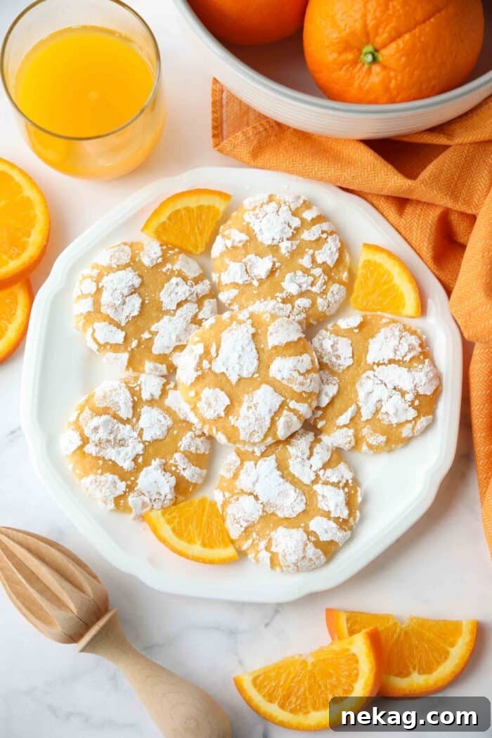 Plate of orange crinkle cookies and orange slices.