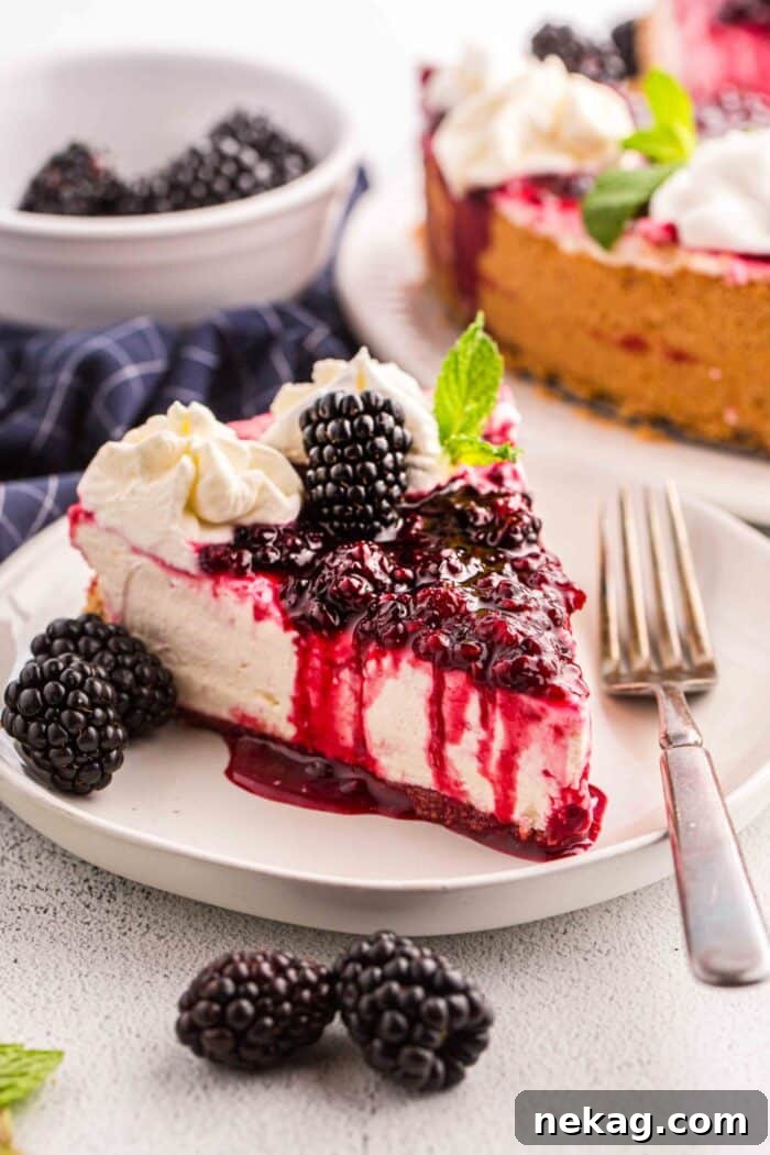 Slice of no bake blackberry cheesecake on a plate with a fork.