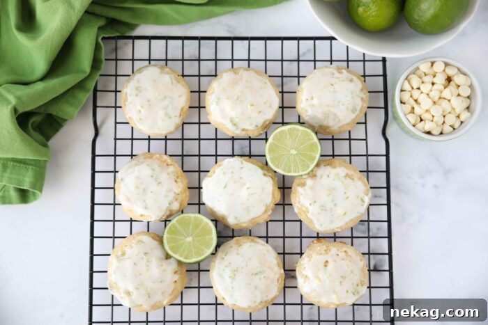 Top view of key lime cookies with glaze on wire cooling rack.
