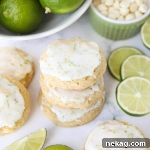 Stack of key lime cookies with white chocolate chips and a lime glaze.