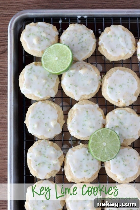 Key lime cookies on a wire rack with a pan underneath to catch the dripping glaze on top.