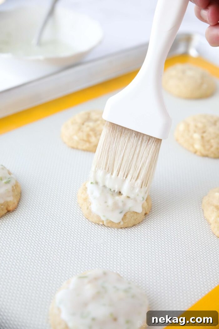 Brushing glaze on warm key lime cookies.