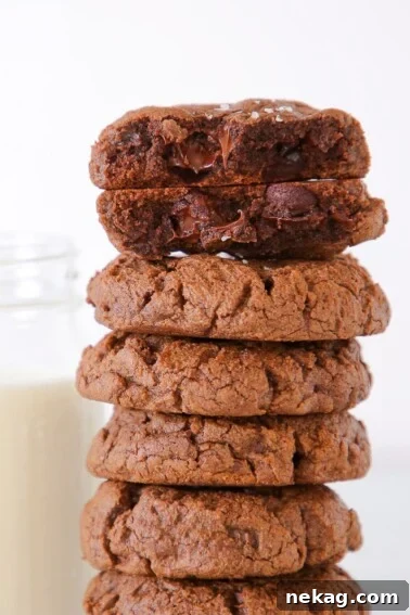 double Chocolate Chip Cookies Stacked next to milk.