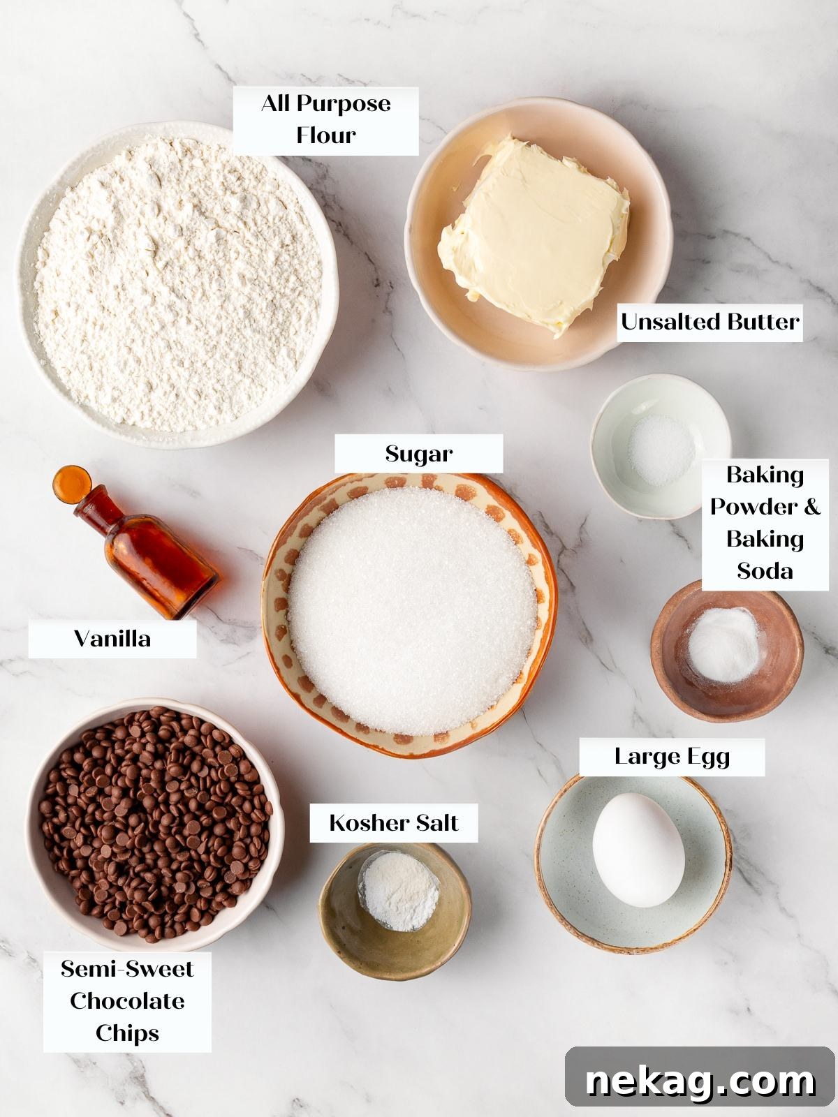 All cookie ingredients arranged on countertop including flour, butter, sugar, and chocolate chips.