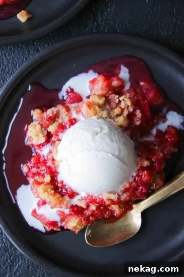 Grandmas Raspberry Rhubarb Crumble black plate gold spoon.