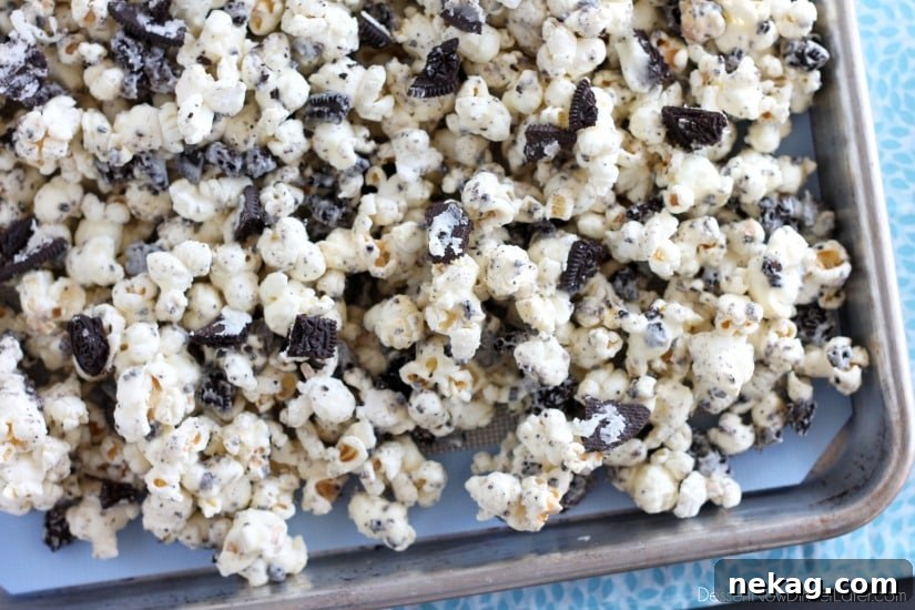 Cookies and Cream Popcorn - white chocolate and Oreos come together to flavor this air popped corn! From DessertNowDinnerLater.com