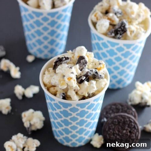 Cookies and Cream Popcorn - white chocolate and Oreos come together to flavor this air popped corn! From DessertNowDinnerLater.com