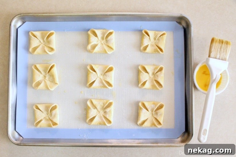 Pumpkin Chocolate Chip Pastries Recipe for Fall Baking Delight 4 Pumpkin Chocolate Chip Pastries - step 2 - fold corners in and egg wash edges
