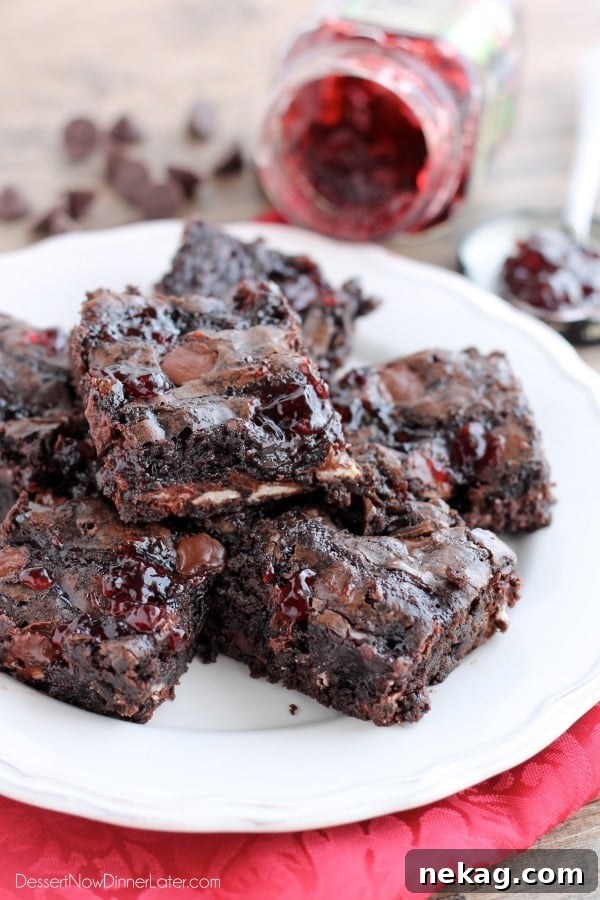 Decadent Dark Chocolate Cherry Brownies Recipe 5 Dark Chocolate Cherry Brownies are made from a doctored box mix that has cherry filled morsels and cherry preserves swirled throughout. From DessertNowDinnerLater.com