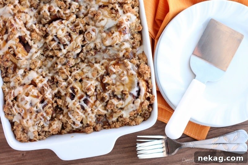 Cinnamon Pumpkin Crumble - frozen cinnamon rolls smothered in pumpkin pie mix, spices, and a crispy-crunchy streusel, then baked to perfection and served with a drizzle of cream cheese frosting and caramel!
