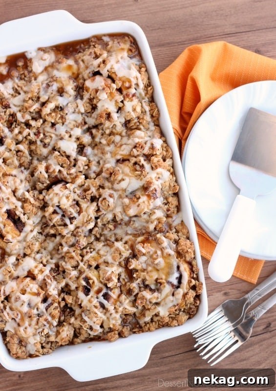 Cinnamon Pumpkin Crumble - frozen cinnamon rolls smothered in pumpkin pie mix, spices, and a crispy-crunchy streusel, then baked to perfection and served with a drizzle of cream cheese frosting and caramel!