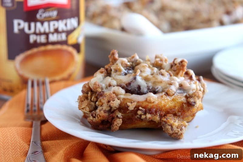 Cinnamon Pumpkin Crumble - frozen cinnamon rolls smothered in pumpkin pie mix, spices, and a crispy-crunchy streusel, then baked to perfection and served with a drizzle of cream cheese frosting and caramel!