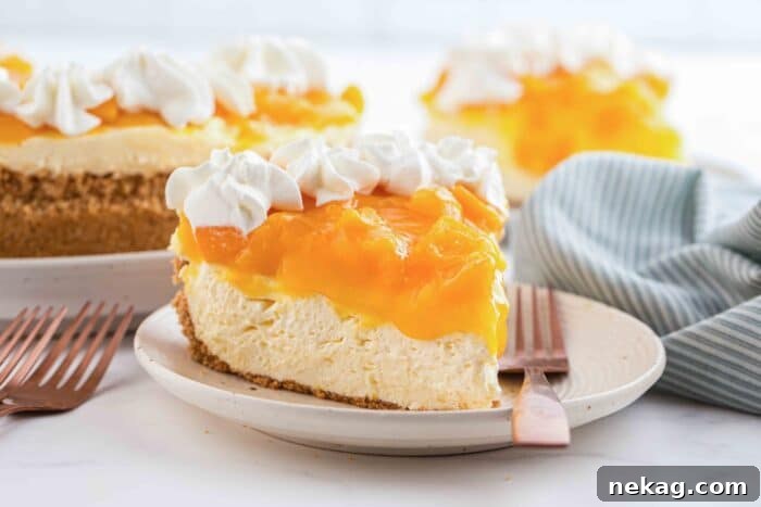 Slice of no bake peach cheesecake on a plate with a fork.