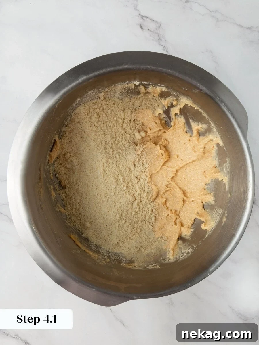 Adding the dry mix gradually keeps the almond flour chocolate chip cookies dough from turning greasy.