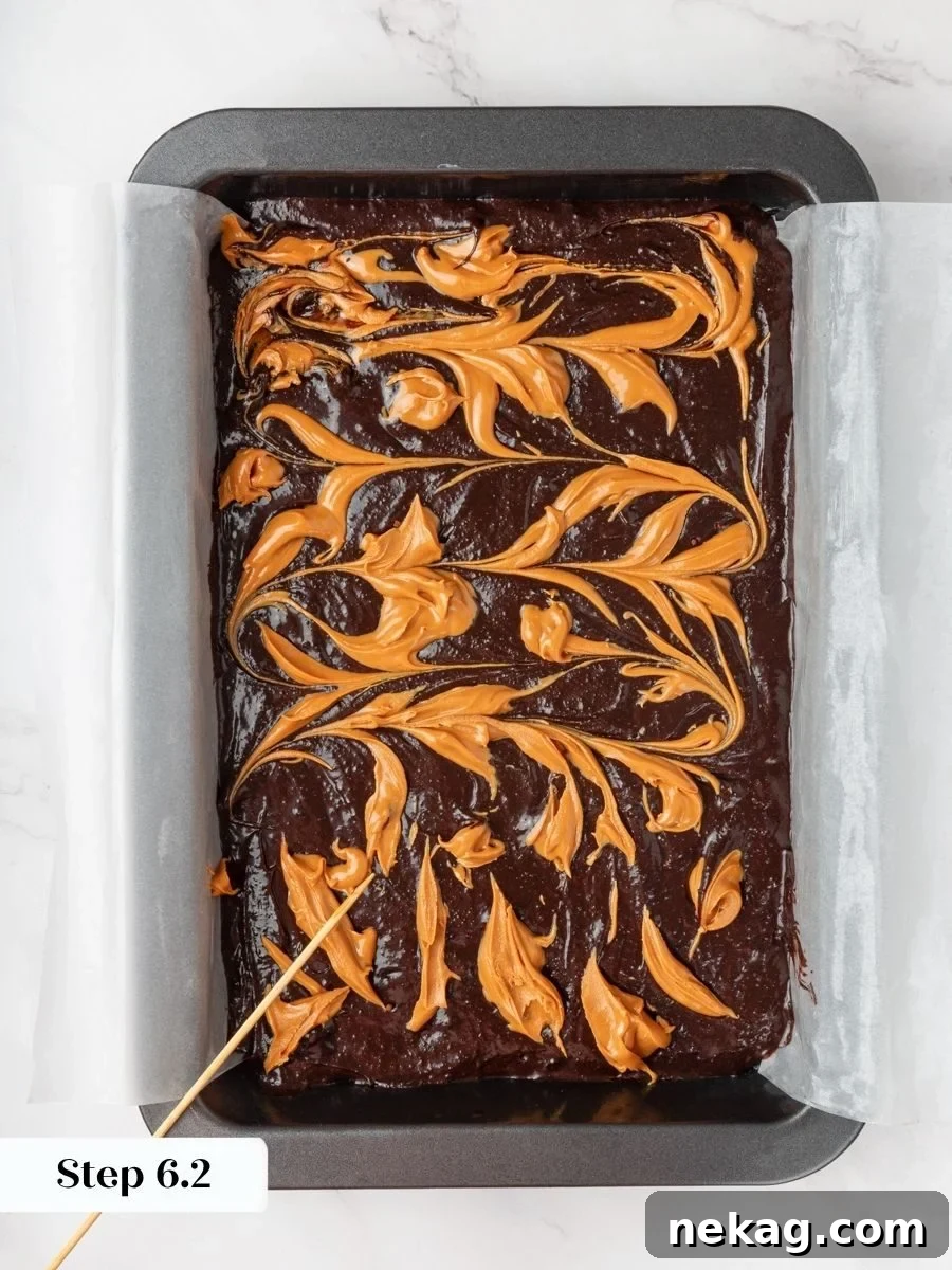 Natural peanut butter ribbons through the batter, the signature swirl that defines these peanut butter brownies.