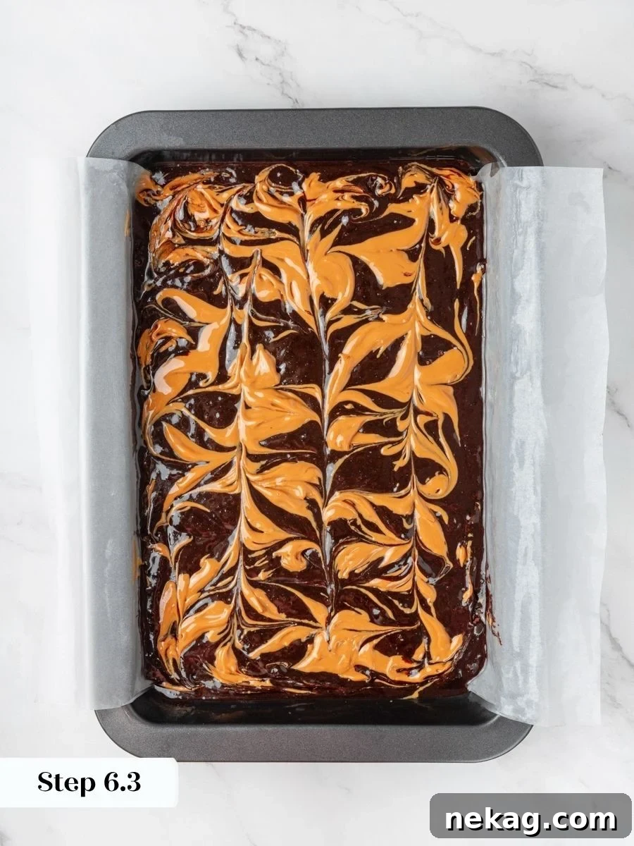 The swirl shows distinct ribbons that keep peanut butter visible in every baked peanut butter brownie.