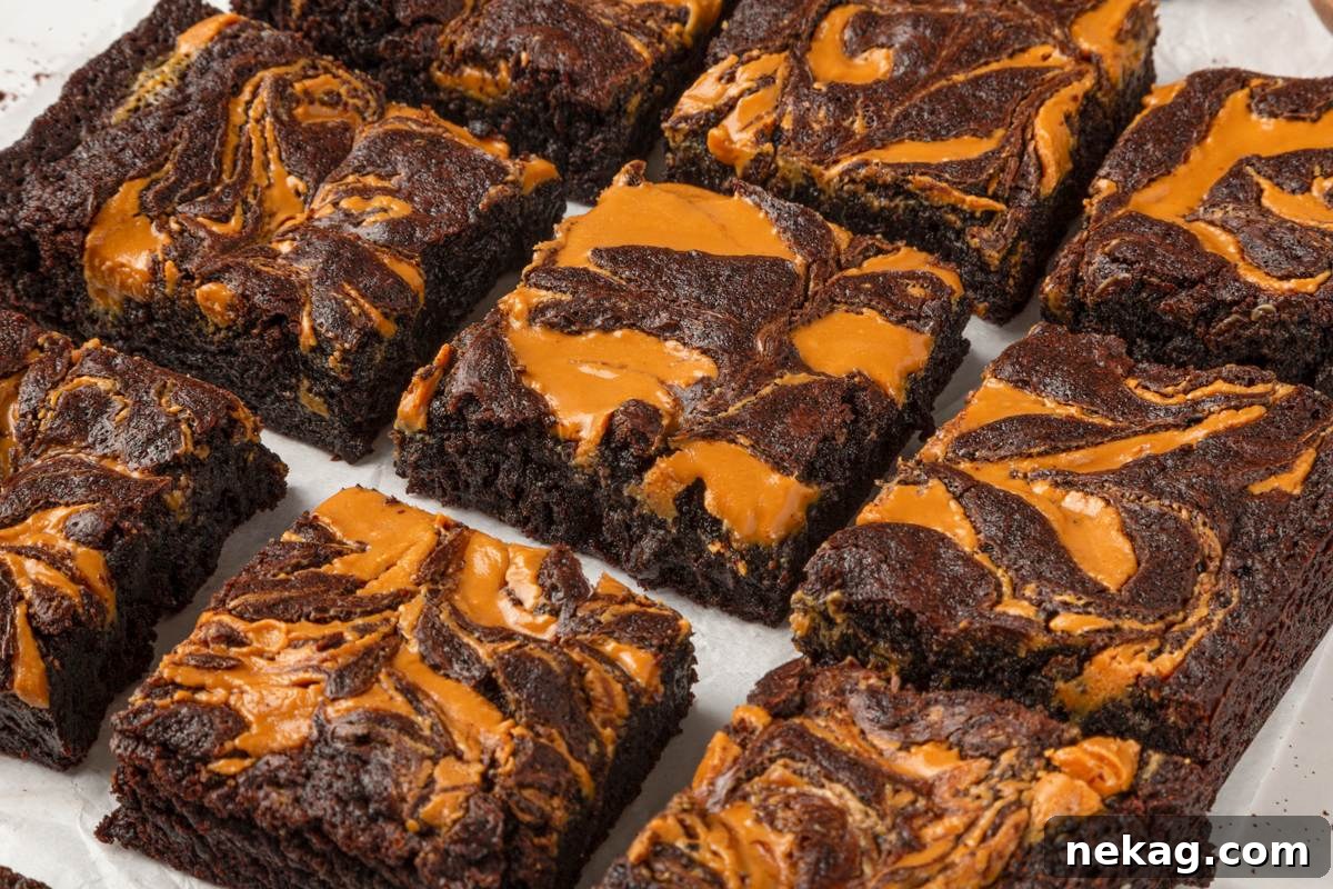 A wide row of peanut butter brownies shows how the swirl marks every single sliced square.