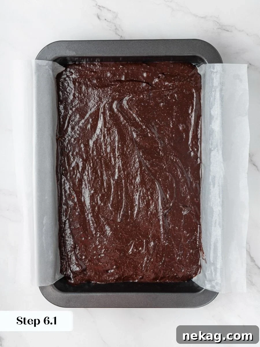An even layer gives the peanut butter brownies a flat base so the swirl reads clearly.