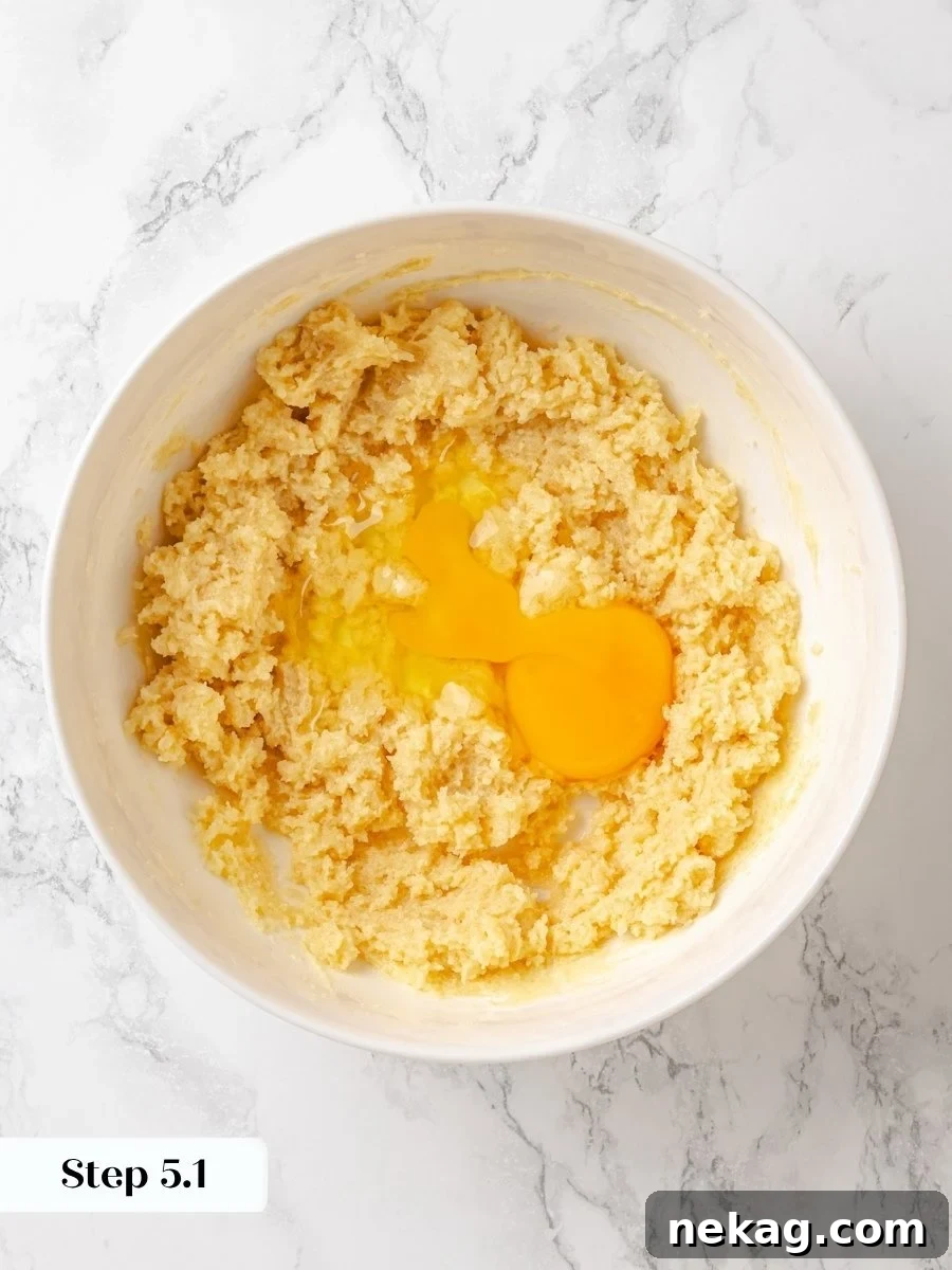 Beating the eggs in one at a time keeps the crumb cake batter smooth and emulsified.
