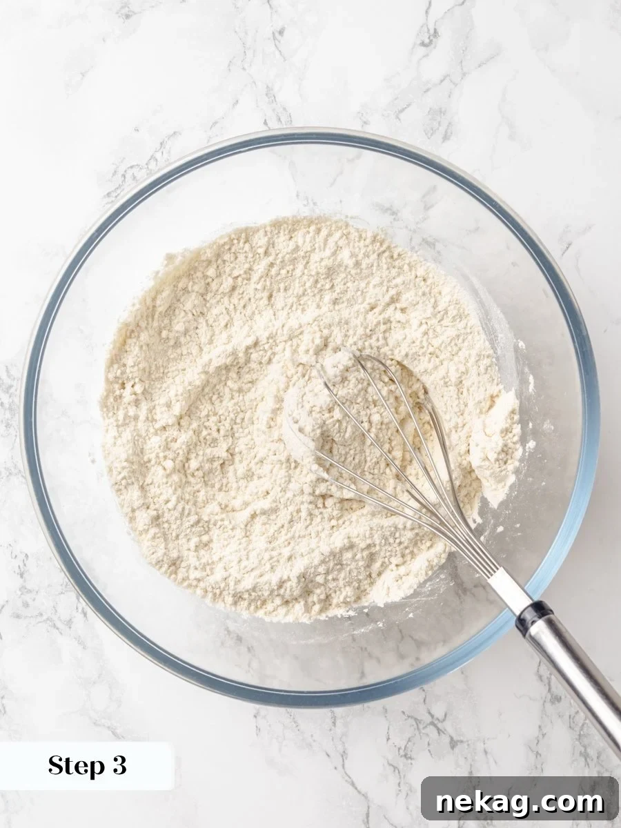 Whisking the dry ingredients first keeps the crumb cake tender rather than dense or unevenly risen.