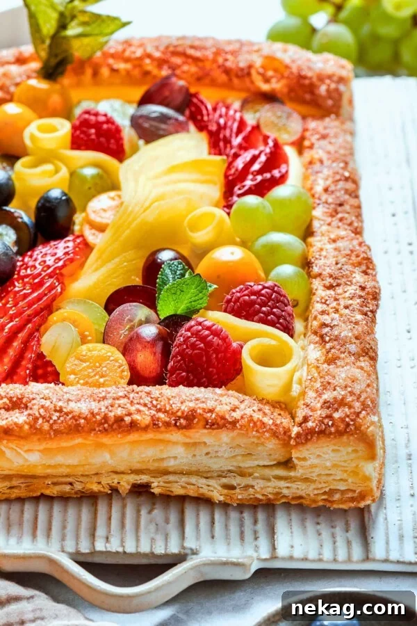 Classic Fresh Fruit Tart with Vanilla Pastry Cream 13 Brightly colored fruit tart presented against white background for clean, simple contrast.