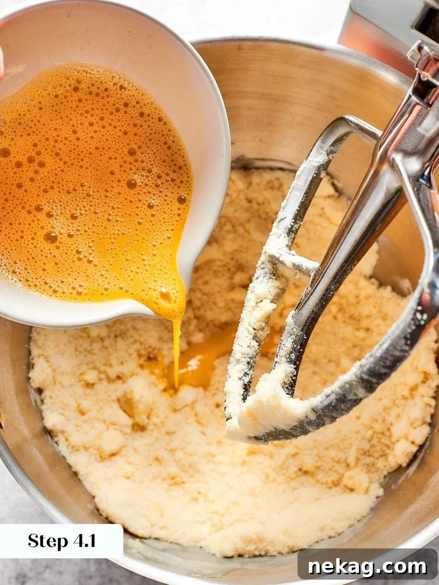 Whisking the egg and yolk first keeps pâte sablée evenly hydrated with no sticky patches.
