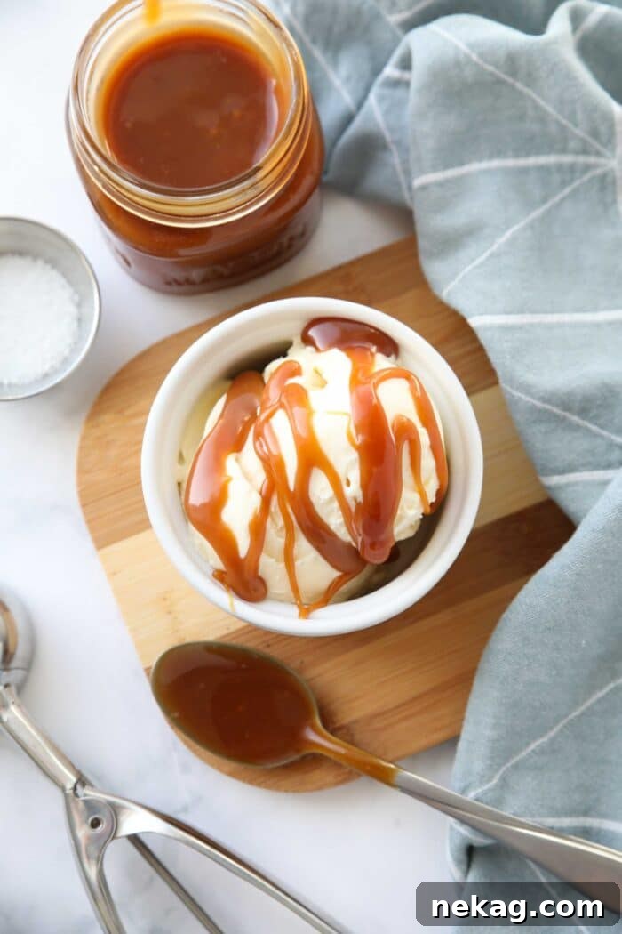 Homemade Salted Caramel Sauce Recipe 9 Homemade salted caramel sauce drizzled on top of ice cream in a bowl.