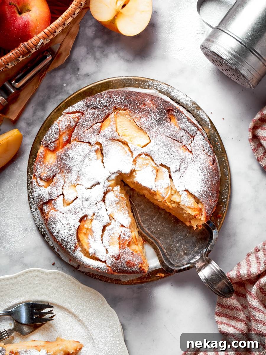 Classic French Apple Cake Recipe 2 Removing the first slice shows the frangipane-like interior that makes this french apple cake unforgettable.