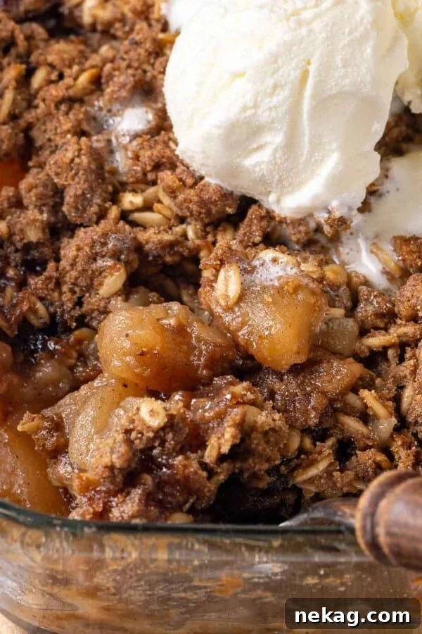 baked apple crisp being dished.