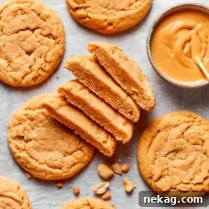 Cut and whole together show the crackled top and soft interior of chewy peanut butter cookies.