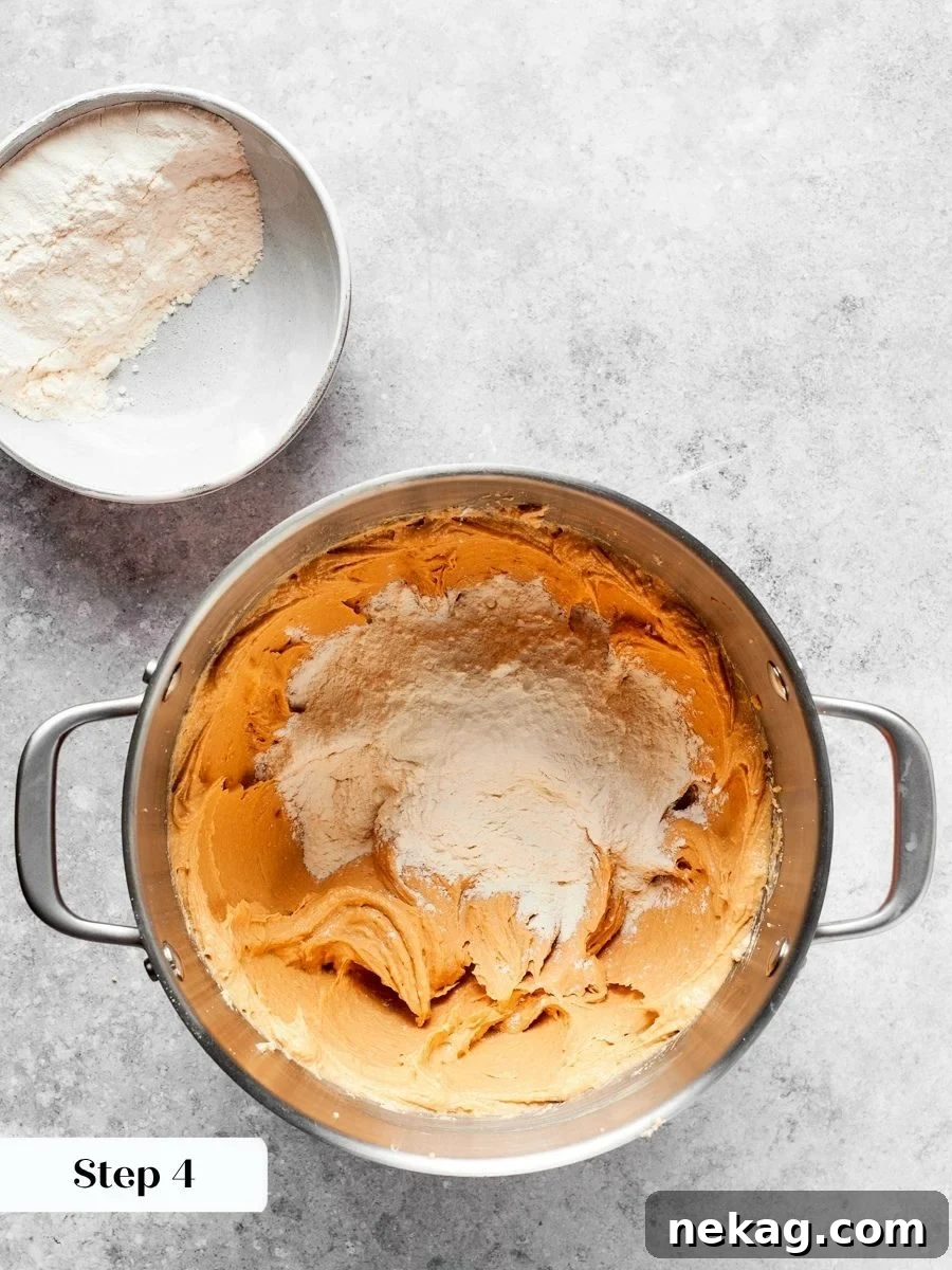 Adding flour in three stages gives better control over the final chewy peanut butter cookies texture.
