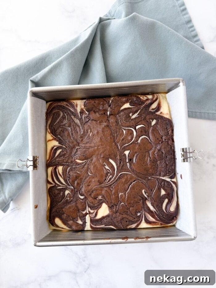 Fudgy Cheesecake Brownies Recipe 8 Cheesecake swirl brownies in pan.