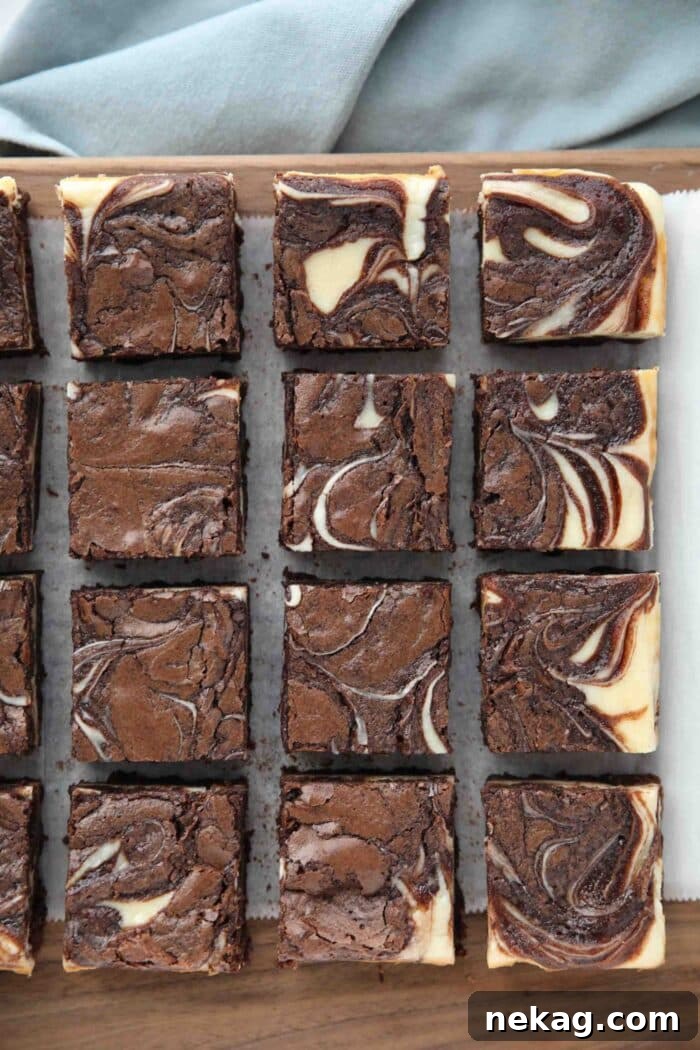 Fudgy Cheesecake Brownies Recipe 9 Cutting board with cream cheese brownies.